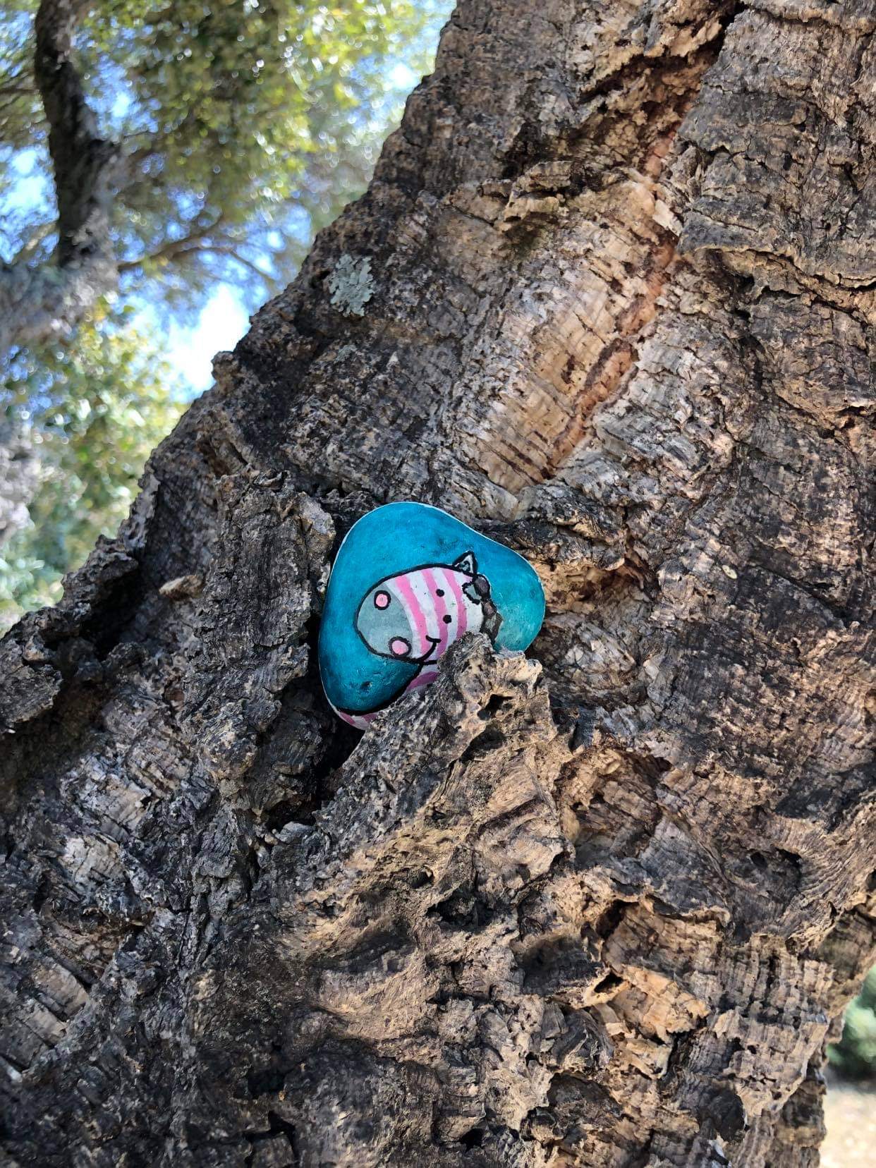 Galet peint Miss zèbrelle déposé au creux d'un arbre